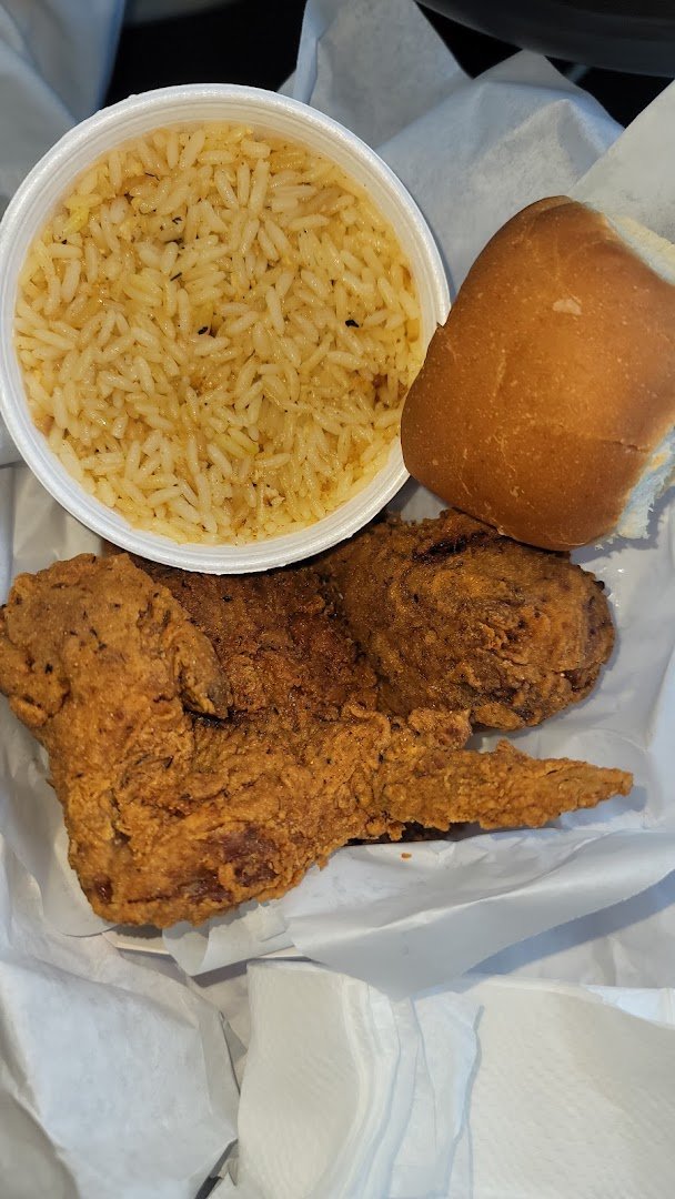 Crispy chicken wings beside dipping sauce.
